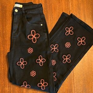 Chic Black Jeans with Red Floral Patterns